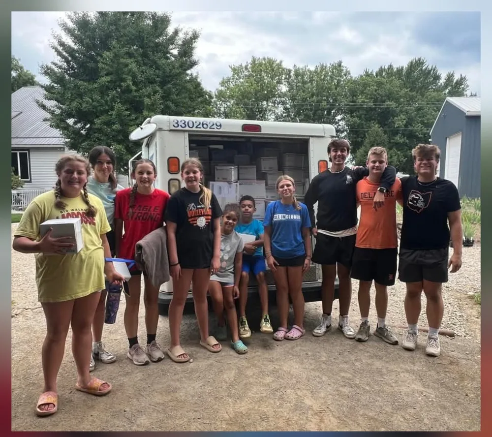 The PetalsWings family crew in front of the USPS mail truck